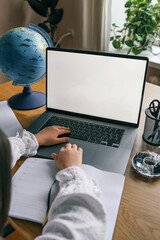 Distance learning online education. A girl studies at home and does school homework. A home...
