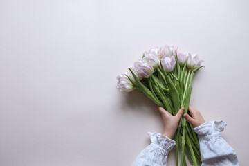 Bouquet of pink tulips on pastel background. Mothers day, Valentines Day, Birthday celebration concept. Greeting card. Copy space for text, top view