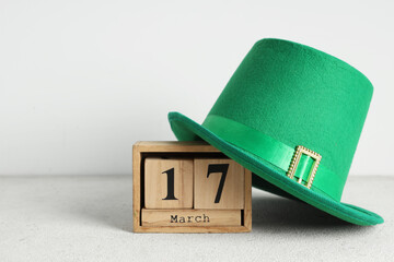 Leprechaun hat with calendar on white grunge background. St. Patrick's Day celebration