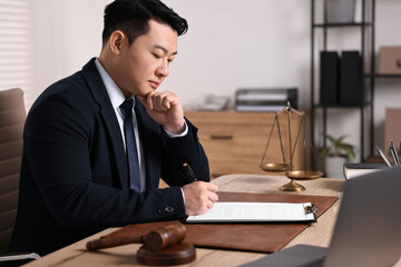 Notary writing notes at wooden table in office - obrazy, fototapety, plakaty