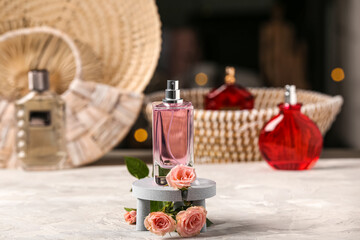Fototapeta na wymiar Pink bottle of perfume with pink roses on table