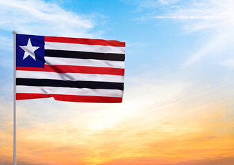3D illustration of a Maranhao flag extended on a flagpole and in the background a beautiful sky with a sunset
