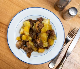 Foto op Plexiglas Appetizing beef stew served with potatoes and mushrooms on platter © JackF