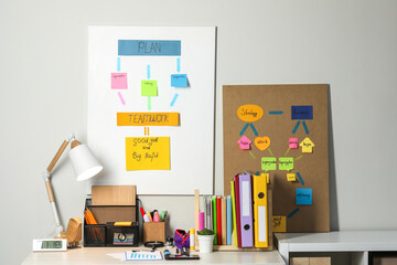 Business process planning and optimization. Workplace with lamp, colorful paper notes and other stationery on table