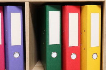 Colorful binder office folders on shelving unit