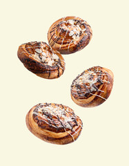 Sweet buns. Delicious rolls with almond flakes falling on beige background