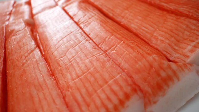 Crab sticks consist mainly of minced Alaskan pollock, water, starch, egg whites, sugar, salt, and occasionally crab flavoring. These are processed and blended to form a paste-like substance. 4K UHD.
