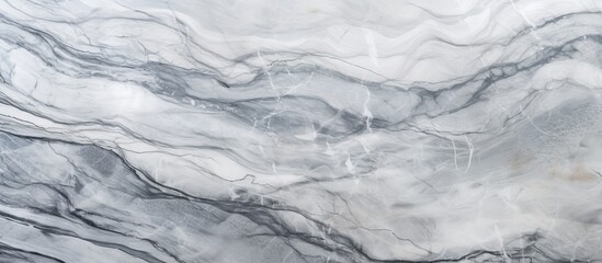 A closeup of a fluid gray and white marble texture resembling a glacial landform. The pattern looks...