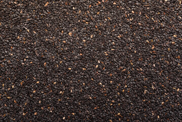 Black sesame seeds, an ingredient for making vegetarian and healthy food. Close-up image of food background texture