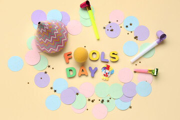 Text FOOLS DAY with clown nose and party decor on beige background