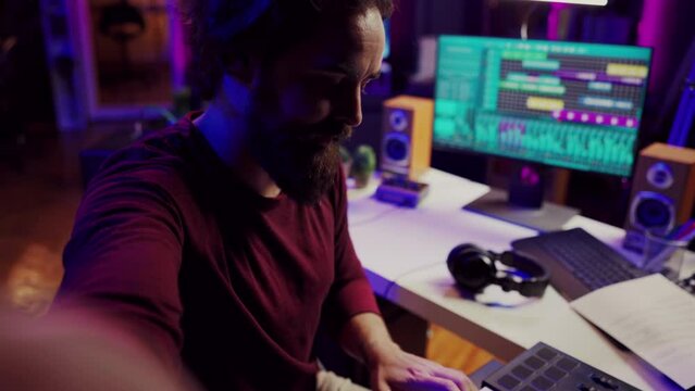 POV of musician playing on synthesizer for online piano lessons in his home studio. Singer songwriter filming vlog teaching about musical instruments, midi controller keyboard. Camera A.