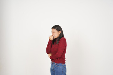 Young Asian woman in Red t-shirt Smelling something stinky and disgusting isolated on white background