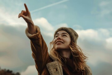 Portrait of woman pointing at the sky, Conceptual image of hope, dream and encouragement