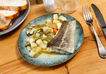 Fried cod fillets are complemented with vegetable stew french green bean vegetable and carrots....