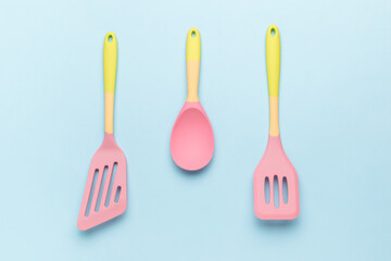 A set of kitchen silicone accessories on a blue background.