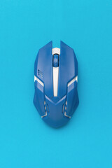 A wireless blue and white computer mouse on a blue background.