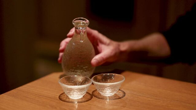 Pouring Sake into Traditional Cups