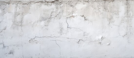 A close up of a grey wall with peeling paint resembles a snowy landscape. The texture is like wood,...