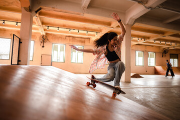 skater woman person playing skateboard in sport gym, young Asian woman are happy and fun with...