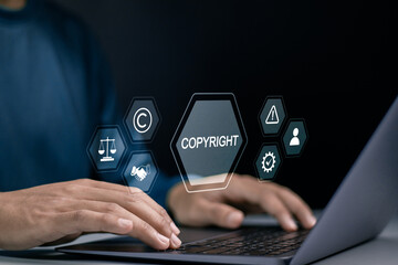 Copyright or patent concept. Author rights and patented intellectual property. copyleft trademark license. Businessman use laptop with copyright icon on virtual screen.