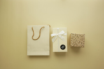 Gift or present box with paper packet on orange color background ,