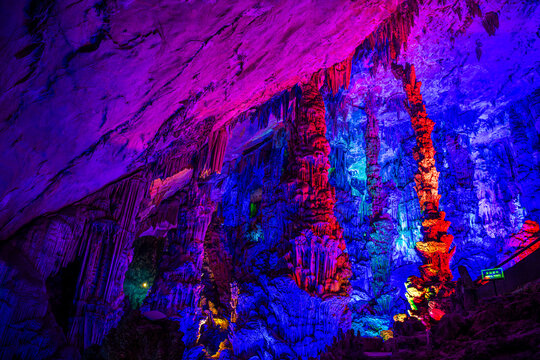 A natural cave in Guilin, China beautifully decorated with colorful lights