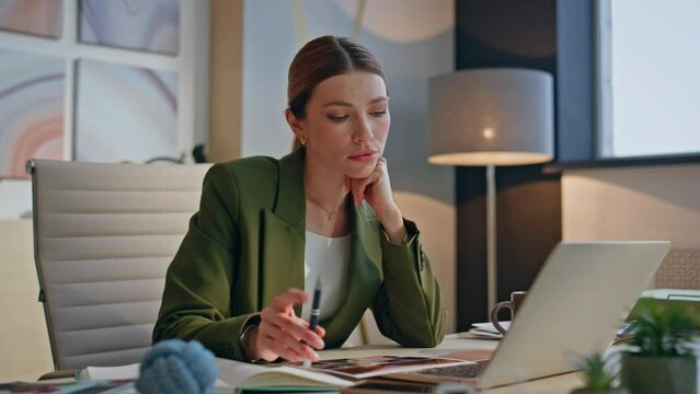Pensive boss looking laptop creating ideas at modern desk closeup. Woman working