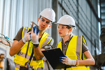 woman engineer in uniform helmet inspection check control heavy machine robot arm construction...