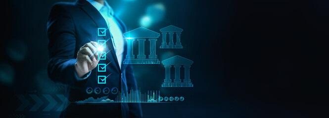 Businessman check digital banking and icons for network connection, online payments, shopping, and digital technology business on a dark blue virtual screen background.