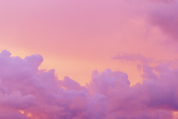 Pastel nature Sunset, purple fluffy clouds on pink colored sky, picturesque landscape pastel tones,...