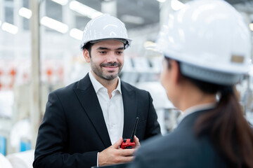 Close-up of a conversation about the work of an American male engineer and a female architect in a...