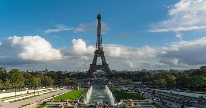 Time lapse of Crowded people Tourist walking and transportation traffic around Eiffel tower in summer season, on the Champ de Mars in Paris, France