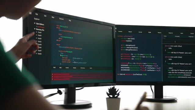 Slow motion back end software developer engineer for computer programming working together on debugging writing computing code, solving complex algorithms display on monitor in office. Burgeoning