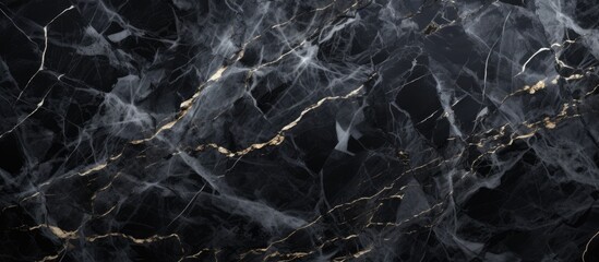 A detailed closeup of a black marble texture with shimmering gold veins running through it, resembling a landscape of dark rock and flowing water
