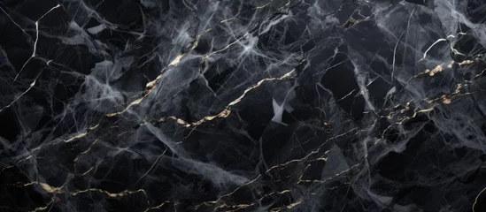 Crédence de cuisine en verre imprimé Gris 2 A detailed closeup of a black marble texture with shimmering gold veins running through it, resembling a landscape of dark rock and flowing water
