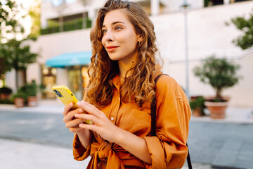 Beautiful woman with phone while walking in the street. Lifestyle, travel, tourism, technology,...