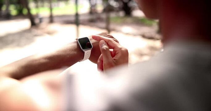 Athlete, hands or runner in park with smart watch for heart rate to monitor training or cardio exercise. Break, race progress or healthy man with technology or timer in running workout or fitness