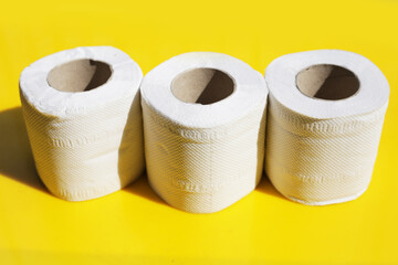 Toilet paper on yellow background.
