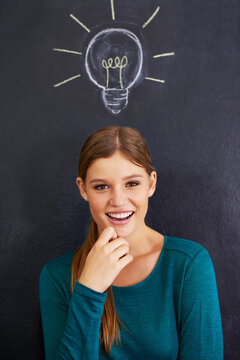Portrait, thinking and woman with light bulb on chalkboard for inspiration, brainstorming and problem solving. Creative, question and person on background with icon for ideas, thoughtful and planning