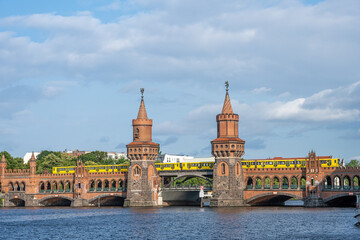 Fototapeta na wymiar The beautiful Oberbaumbruecke in Berlin with a yellow subway train