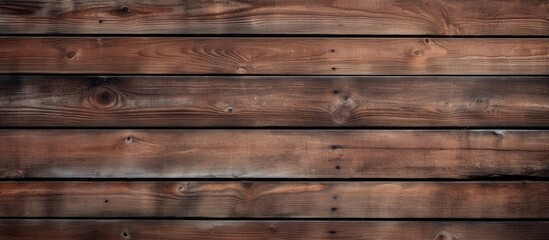 Naklejka premium A close up of a hardwood plank wall with a brown wood stain, creating a beautiful pattern resembling brickwork. The blurred background adds depth to the rectangular shapes