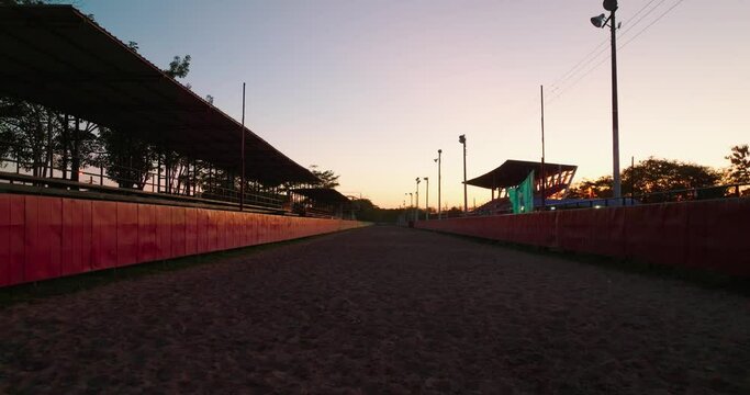 Dawn breaks over the empty race track in Arauca, Colombia, with warm sky hues
