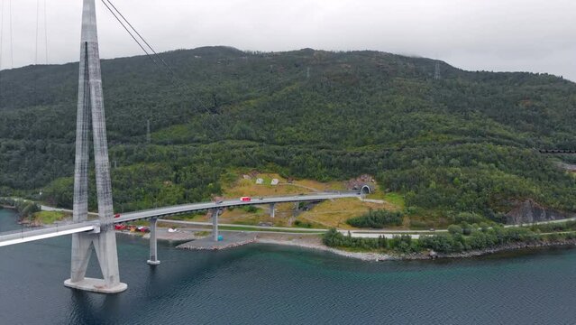 Aerial: H&aring;logaland Bridge seen from the Ofotfjord in Narvik and an ore train in the background