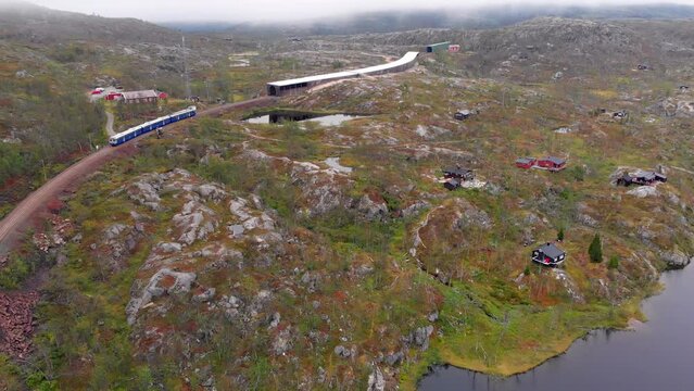 Aerial: norwegian arctic train entering a tunnel in northern Norway
