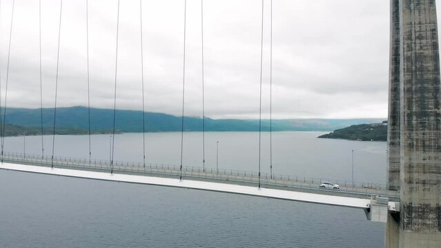 Aerial: H&aring;logaland Bridge seen from the Ofotfjord in Narvik and some cars crossing it