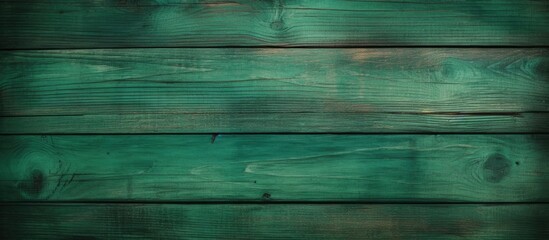 Close up of a patterned green wooden surface, highlighting tints and shades of aqua and electric...