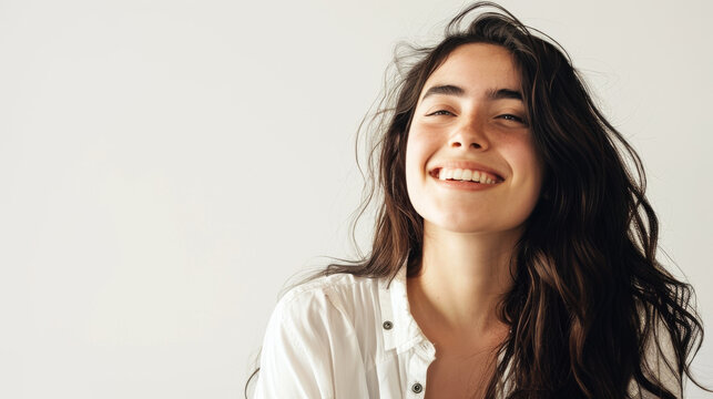 This engaging image portrays a laughing woman with her dark hair tossing freely, giving a sense of joy