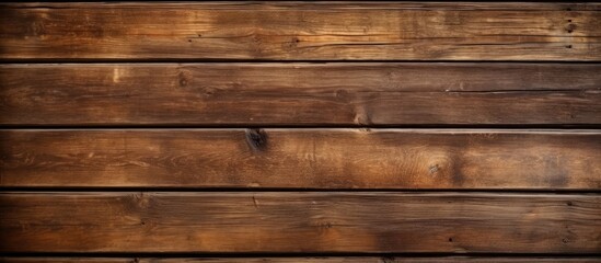 Fototapeta na wymiar A detailed closeup of a brown hardwood plank wall with a distinct grainy texture, featuring an amber wood stain on the rectangular plywood pattern