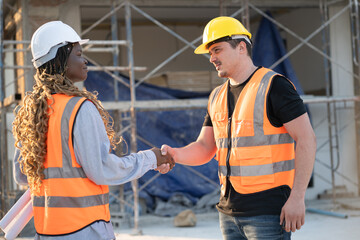 Worker engineer African woman hand shake with caucasian worker and water tank background at construction site	 - 758590948
