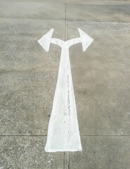arrow in two directions on asphalt